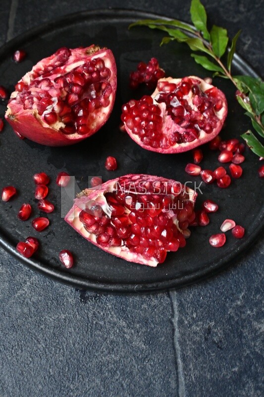 Pomegranates on a black plate​