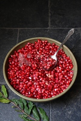 Bowl of pomegranates with a spoon