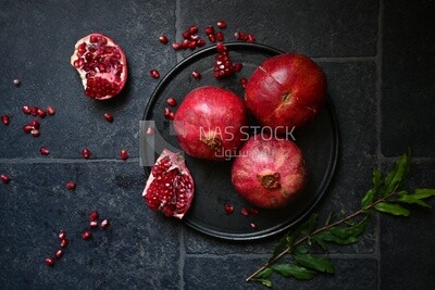 Pomegranates on a black plate​
