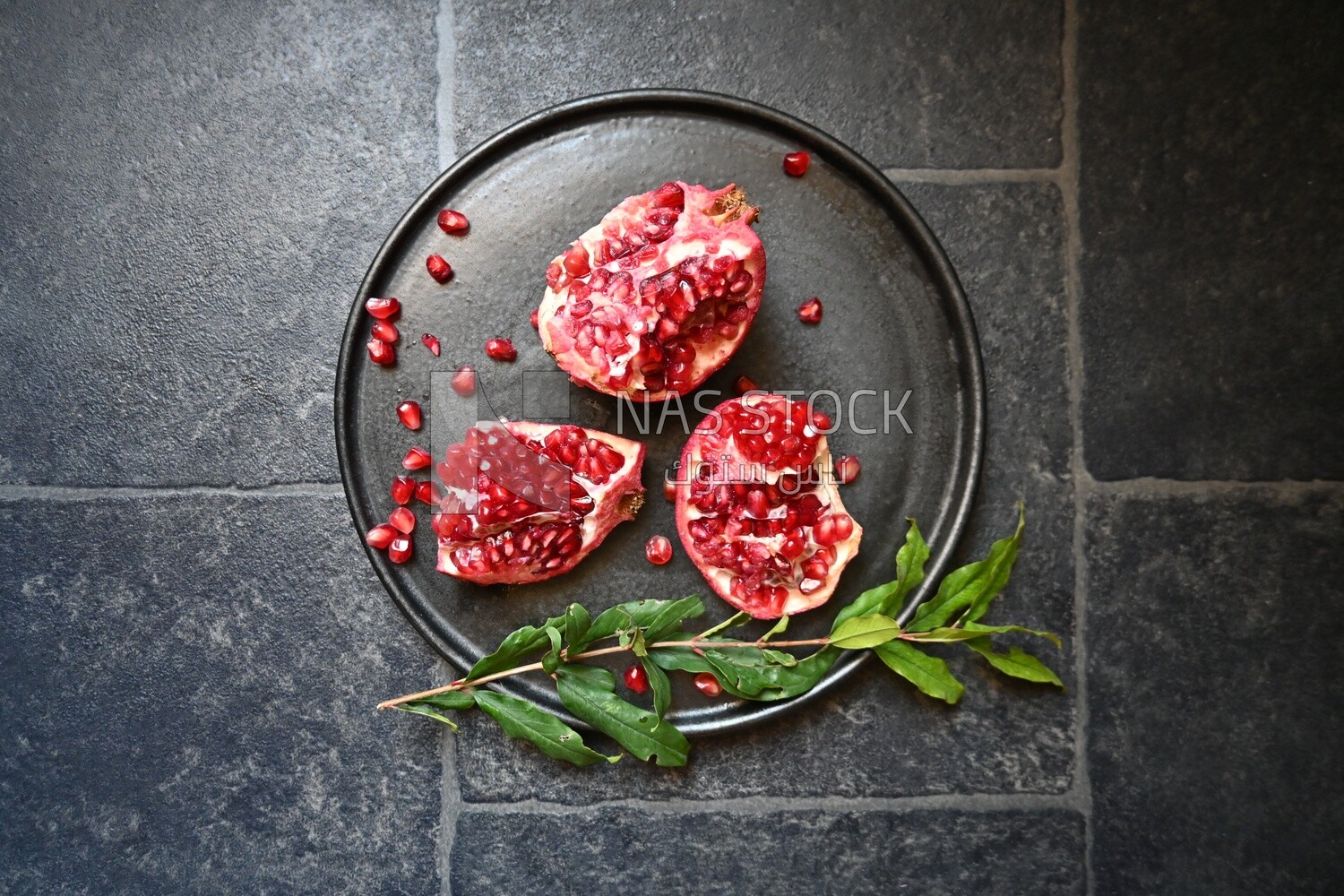 Pomegranates on a black plate​