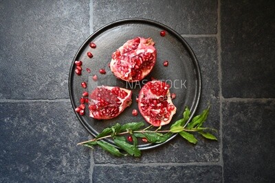 Pomegranates on a black plate​