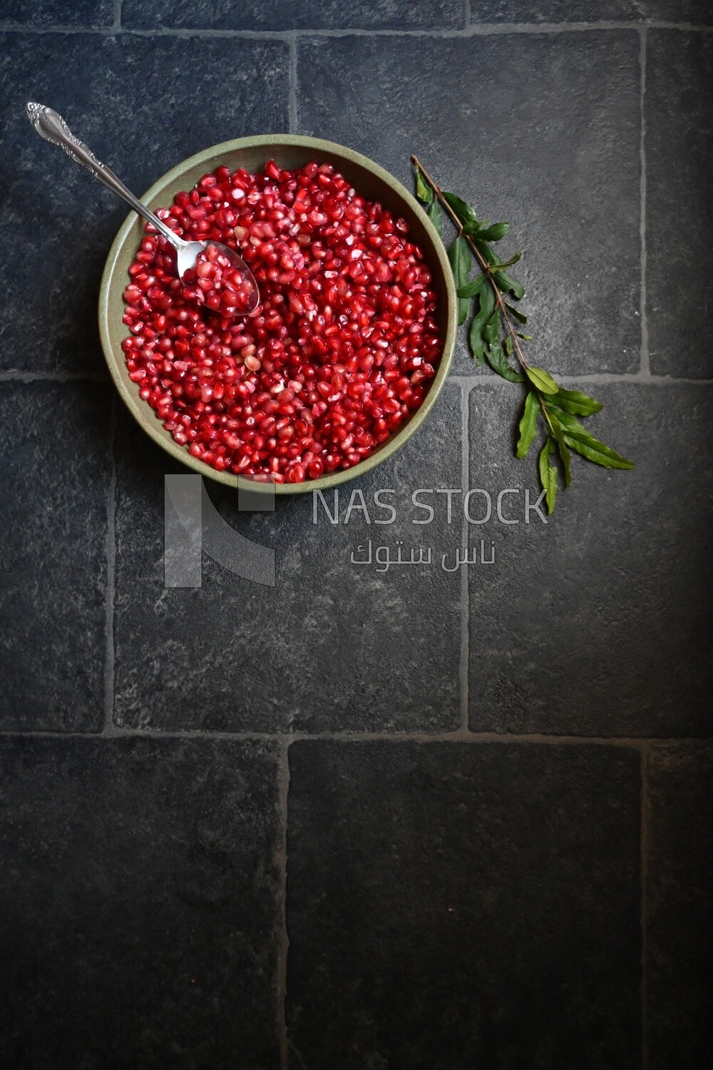 Bowl of pomegranates with a spoon