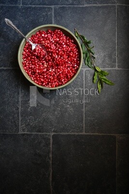 Bowl of pomegranates with a spoon