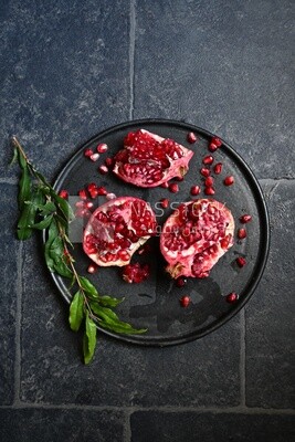Pomegranates on a black plate​