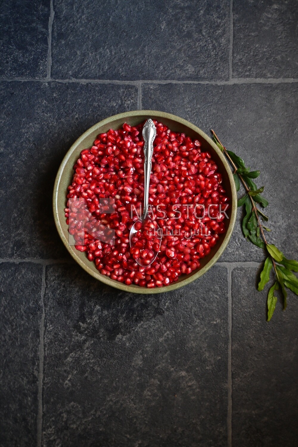 Bowl of pomegranates with a spoon​
