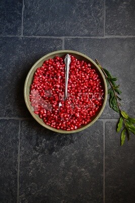 Bowl of pomegranates with a spoon​