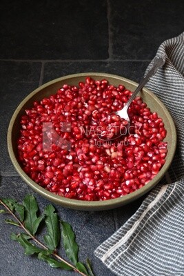 Bowl of pomegranates with a spoon