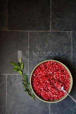 Bowl of pomegranates with a spoon​