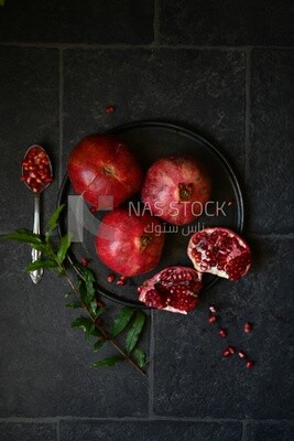 Pomegranates on a black plate​