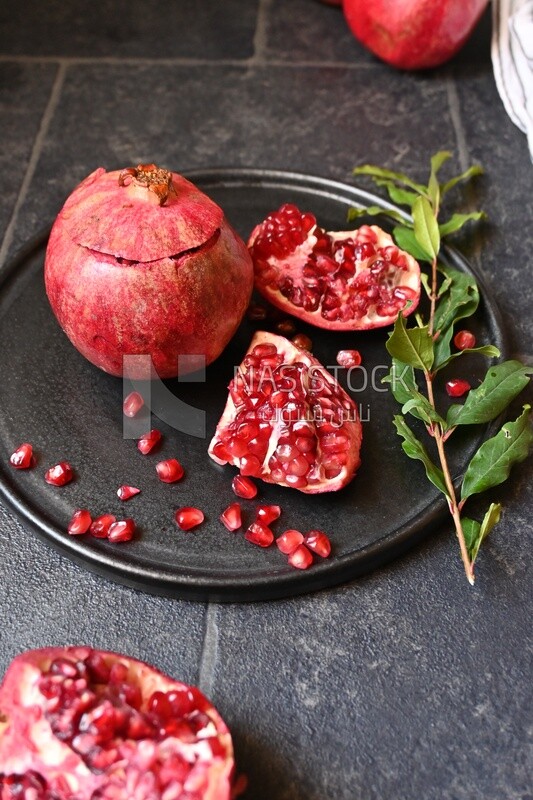 Pomegranates on a black plate​