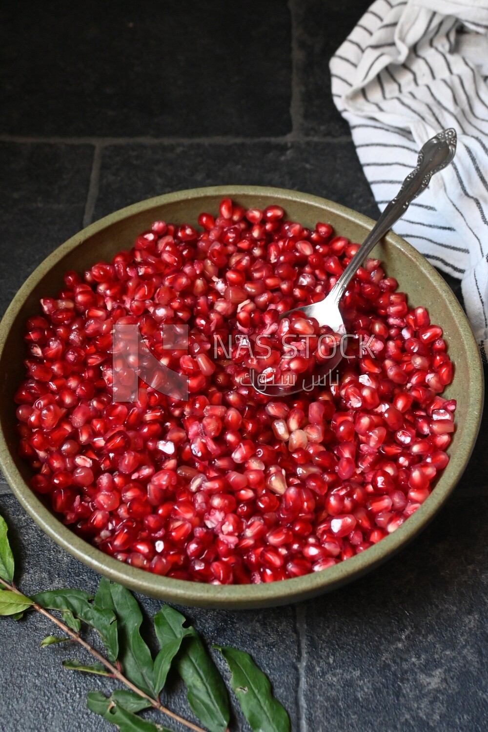 Bowl of pomegranates with a spoon
