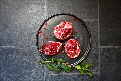 Pomegranates on a black plate​
