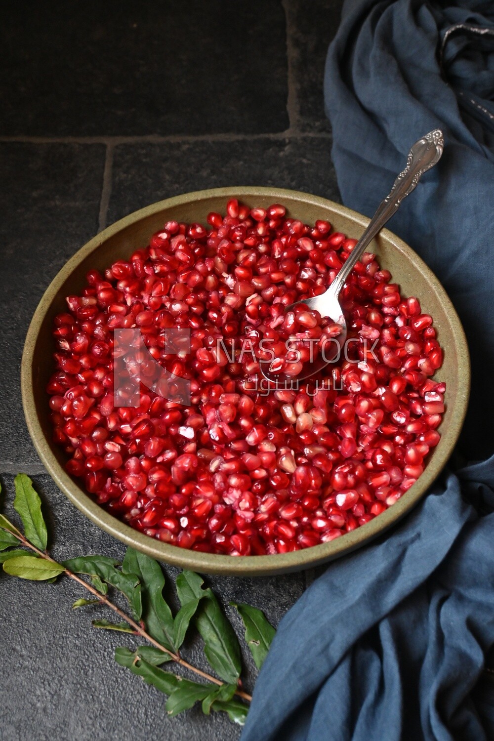 Bowl of pomegranates with a spoon