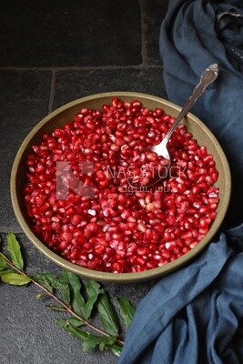 Bowl of pomegranates with a spoon