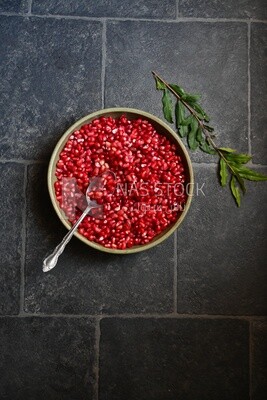 Bowl of pomegranates with a spoon​