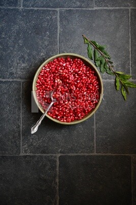 Bowl of pomegranates with a spoon​