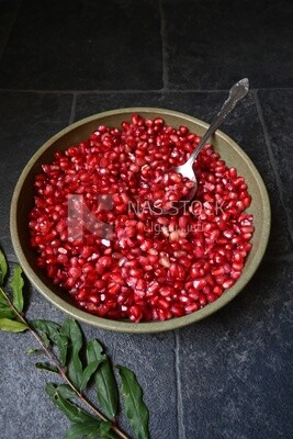 Bowl of pomegranates with a spoon​