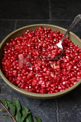 Bowl of pomegranates with a spoon