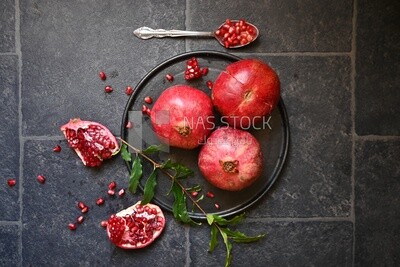 Pomegranates on a black plate​