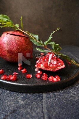 Pomegranates on a black plate​