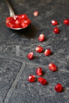 Seeds of pomegranates​​ in a spoon