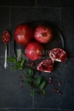 Pomegranates on a black plate​