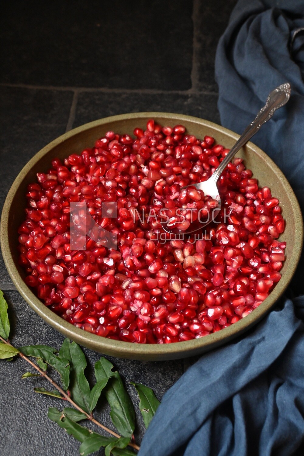 Bowl of pomegranates with a spoon
