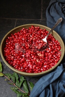 Bowl of pomegranates with a spoon