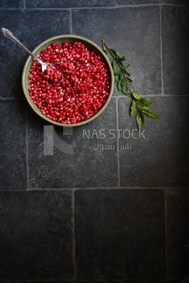Bowl of pomegranates with a spoon