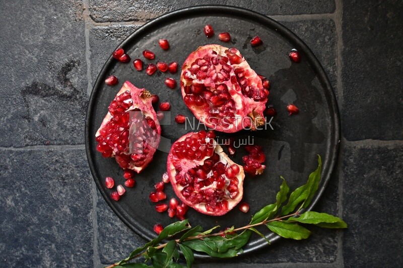 Pomegranates on a black plate​