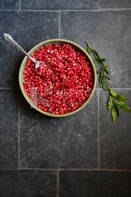 Bowl of pomegranates with a spoon​