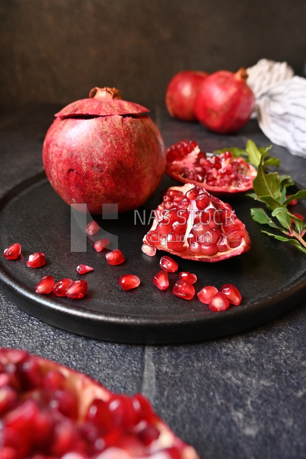Pomegranates on a black plate​