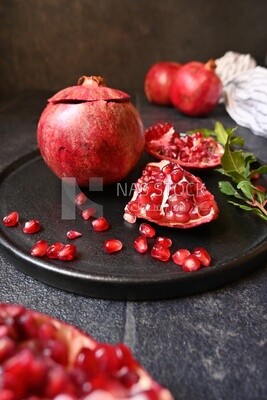 Pomegranates on a black plate​