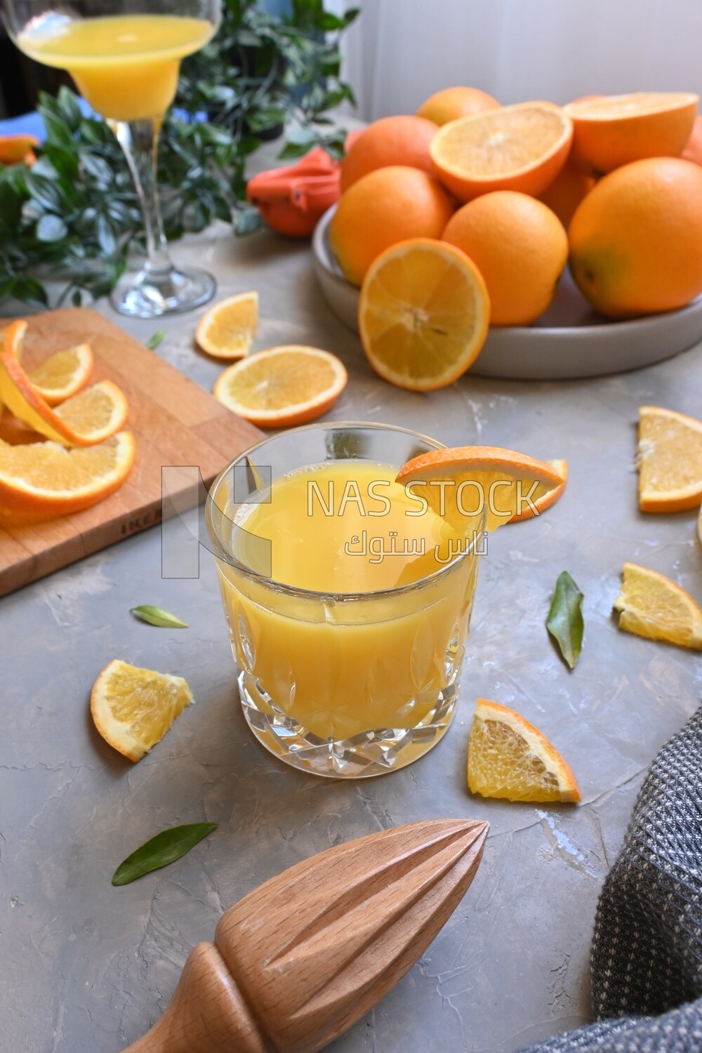 Plate of oranges with a fresh glass of orange juice