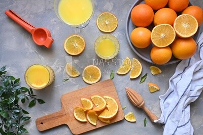 Plate of oranges with a fresh glass of orange juice