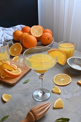 Plate of oranges with a fresh glass of orange juice