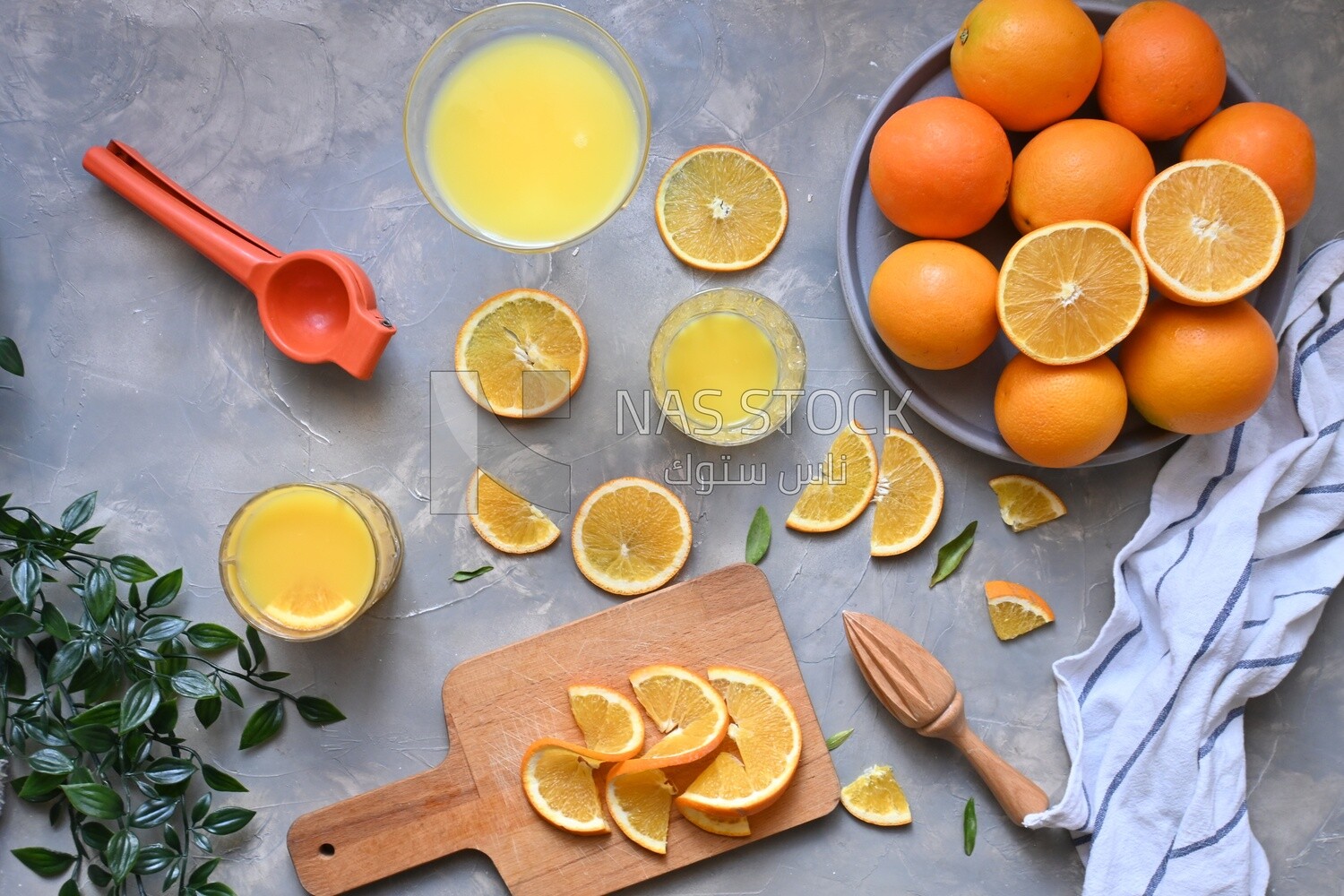 Plate of oranges with a fresh glass of orange juice