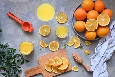 Plate of oranges with a fresh glass of orange juice