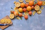 Oranges with a knife and orange slices on the table ​