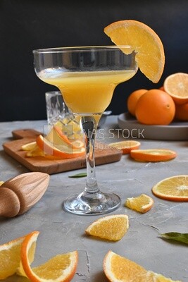 Glass of orange juice with a wooden citrus juicer