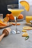 Glass of orange juice with a wooden citrus juicer