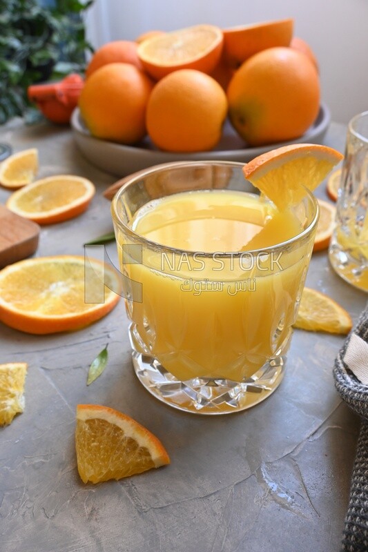 Plate of oranges with a fresh glass of orange juice​