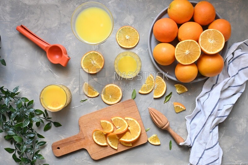 Plate of oranges with a fresh glass of orange juice