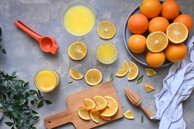 Plate of oranges with a fresh glass of orange juice​