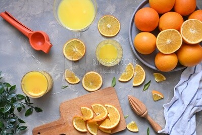 Glass of orange juice with a wooden citrus juicer