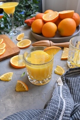 Plate of oranges with a fresh glass of orange juice​