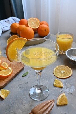 Glass of orange juice with a wooden citrus juicer