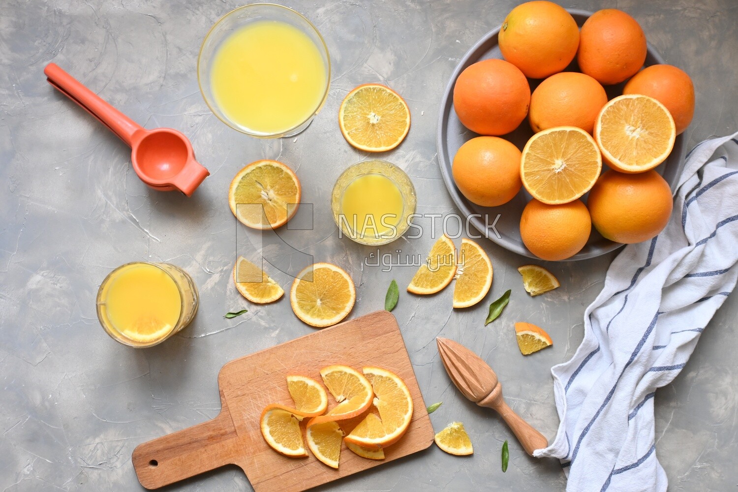 Plate of oranges with a fresh glass of orange juice​