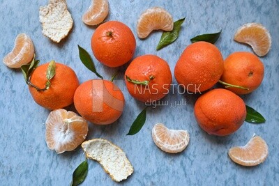 Tangerine with tangerine slices on a blue background