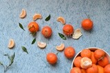 Tangerine with tangerine slices on a blue background